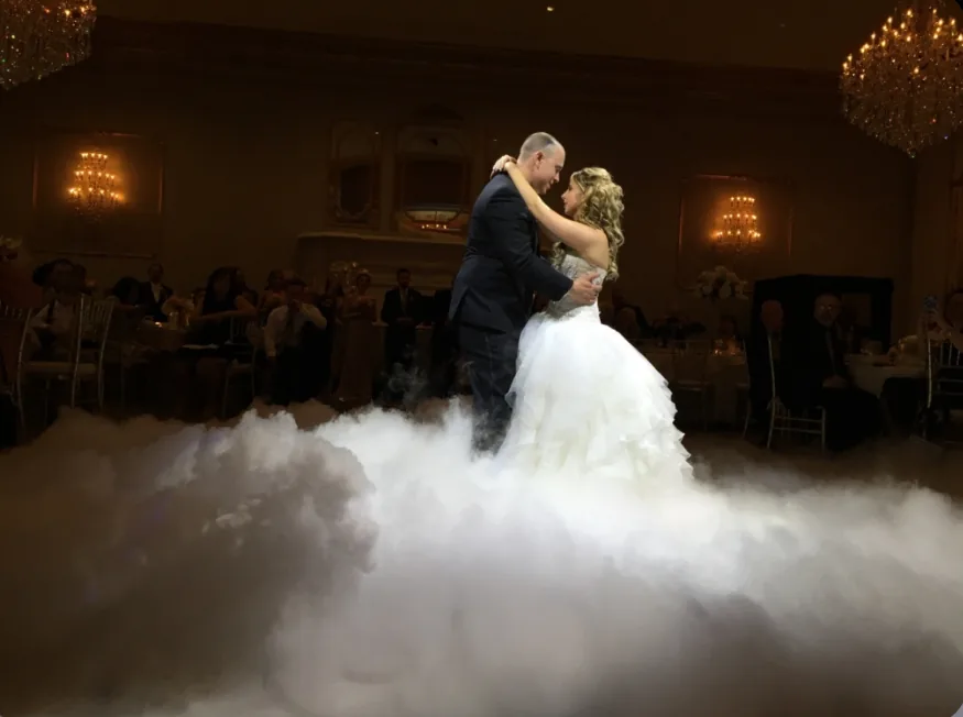 A couple's first dance surrounded by a low cloud of dry ice